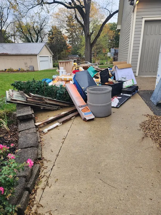 Dumpster being loaded with debris for Commercial Dumpster Rental in Huntersville